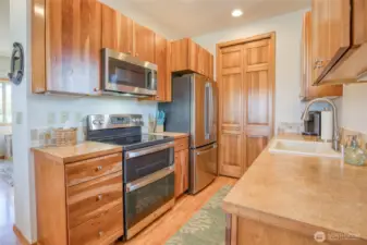 Beautiful kitchen with new stainless steel appliances in 2022 and tile backsplash