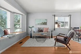 Enter and find natural light beaming from the bay windows