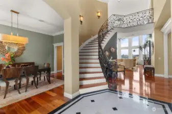 The flooring, banister, sweeping staircase and two-story-view-wall of windows individually would be incredible . . . combined, it makes for a phenomenal entry experience.