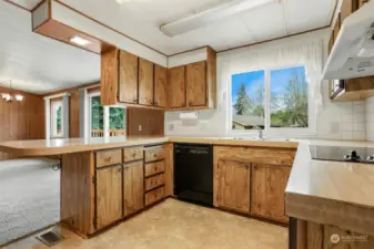 Spacious kitchen with an eating bar, lake views, wall oven, cooktop and pantry.  Opens to family room.