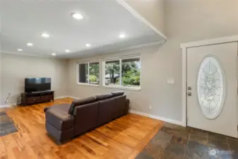 Family room with nice oak flooring & slate entry.