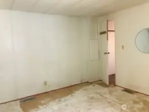 Primary Bedroom needs cosmetic repairs. New paint and new flooring would make this large room shine!