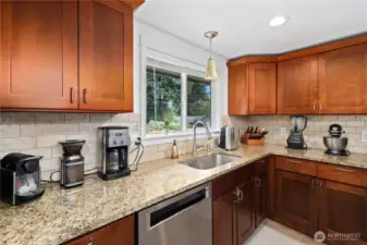 Kitchen with the deep wood cupboards. Full bucket sink with window that looks out front yard.