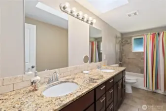 Full bathroom with double granite sinks