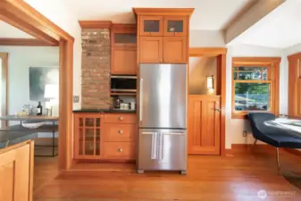 Exposed brick & fir make this kitchen just perfect! Dutch door to the right of fridge heads to the basement