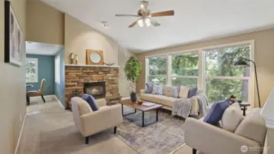 Soaring vaulted ceilings and expansive windows fill this bright and airy living room with natural light—perfect for relaxing or gathering.