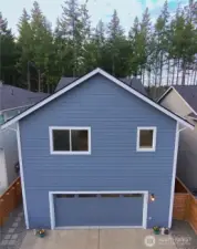 Back of home with 2 car garage faces cul-de-sac/alleyway access to street