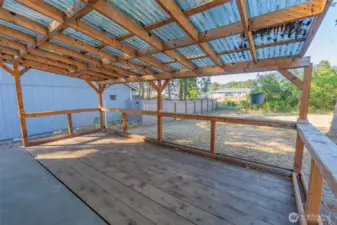 Covered deck overlooking the fenced back yard.