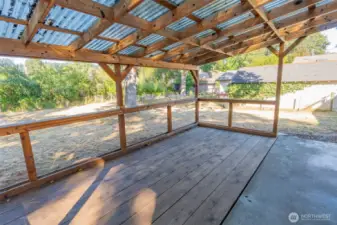 Spacious covered patio allowing for natural lighting and an inviting outdoor living space with a rustic charm.