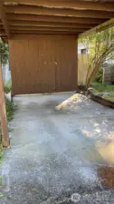 Carport with storage shed.