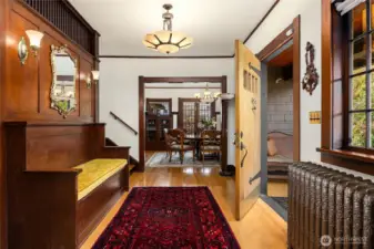 The spacious entry features the original 4' door, stripped & refinished. The original paneled built-in bench with storage. The owners had custom ordered Italian chandeliers. Century-old glass in the wall sconces.