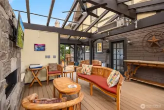 Designed in 2023 by Steven Sparks Architecture, a glass roofed entertaining deck room with a built-in BBQ makes for a great party room.