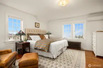 The primary bedroom as the second floor upstairs are old growth fir floors. A Juliet balcony brings expansive views to room. Not shown is a large walk-in closet with a flexible space room used as the owner's morning tv room.