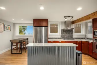 The fully finished LL Guest Quarters has its own separate entrance and/or can be accessed from the main floor of the home. The kitchen is done in slab granite with hardwood floors, custom cabinets & newer appliances with a wonderful view of the Bay! This space has living/tv area, sleeping nook, and bath with fully tiled shower. Miele Washer and Dryers as well.