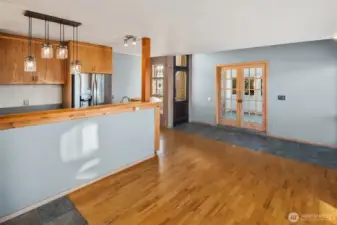 Bright, functional kitchen featuring sleek stainless steel fridge and long, handy countertops.