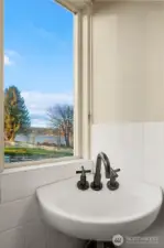 Upper level half bath w/garden and water views.