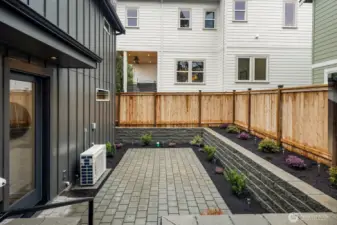 Fully fenced backyard patio.