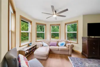 Sitting area with forest views in the primary bedroom.
