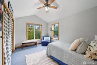 Upper-level guest room with abundant natural light.