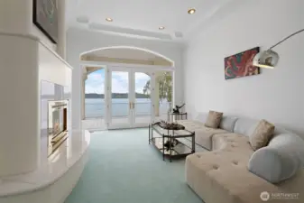 Living room on the main floor with a fireplace and custom furniture.