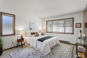 The spacious primary bedroom provides a peaceful sanctuary. New carpet and paint throughout.