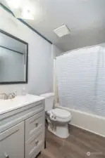 THE BATHROOM | Features a tub/shower unit and an updated vanity.