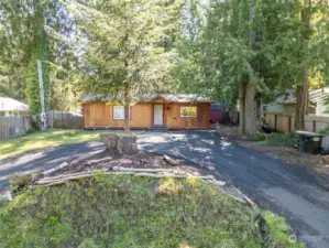 NESTLED IN THE TREES | You'll appreciate the way this home sits back from the road on a circular driveway.