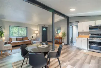OPEN CONCEPT LIVING | The new LVP flooring rolls through the kitchen, dining and living room. With fresh paint on the walls, this home is move in ready.