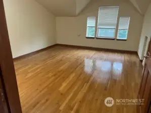 The main bedroom is on the top floor. This room is very large! Hard to tell in the picture! It could easily hold a king bed and sitting area.