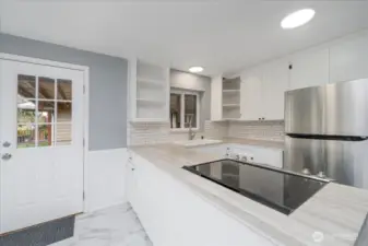Entry into the kitchen/dining area from the covered driveway.