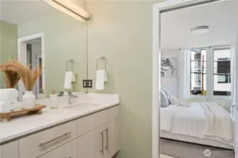 Hall bath with large walk-in shower adjoins primary bedroom.