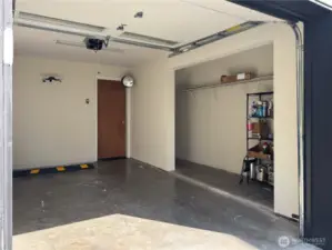 Attached 1-car garage with storage alcove