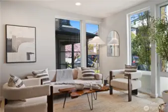 Light filled living/dining room with floor to ceiling windows