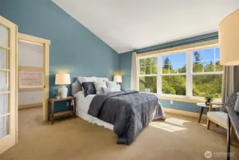 Vaulted ceiling and large windows bathe the room in natural light