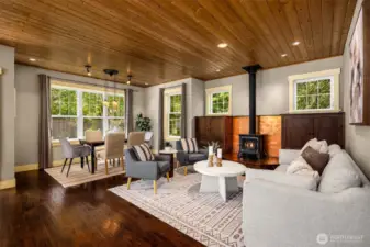 The open-concept living area has a warm, timeless feel and features pine ceilings and designer finishes