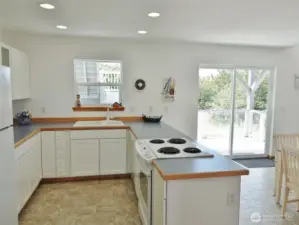 Lovely Kitchen w/ white cabinets and lots of counter space.