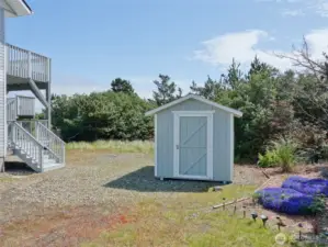 Side yard with Shed leading into the backyard. City-owned Greenbelt located behind the lot.