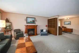 Spacious living room with electric fireplace.