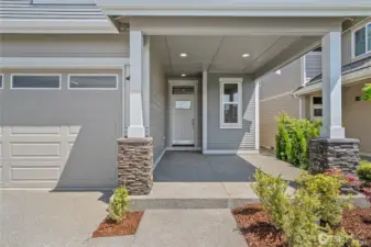 Relax and enjoy the oversized covered front porch with decorative stone panels.