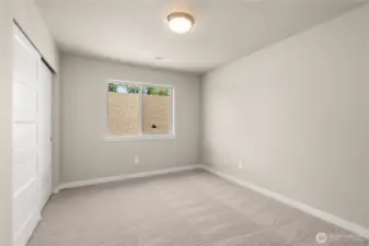 Second bedroom  with 8' ceiling with a standard reach-in closet and prewired for internet.