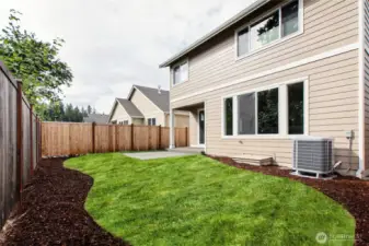 Backyard is landscaped and fully fenced with a patio.