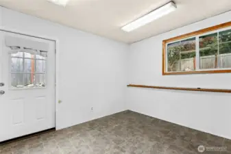Large Utility Room with exterior door and lots of natural light. Possibilities for this space are endless.