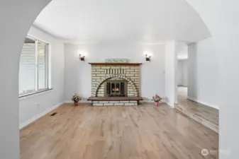 Notice the lovely softly rounded entry to the living room and the newer vinyl plank flooring...bring your furniture and make it your own style!
