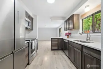 Kitchen looking into family room area, slider off to right goes out to lovely back patio area