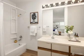 Ensuite bath with new tub surround and flooring. Extra large vanity offers plenty of storage space.