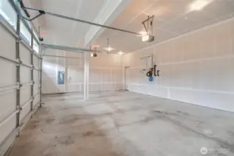 3 car garage has mandoor to backyard