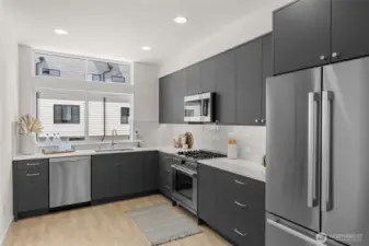 Stainless appliances glisten against a backdrop of modern cabinetry offering both style and function.