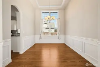 A spacious dining area offers room for both intimate meals and larger celebrations. Natural light enhances the inviting atmosphere. It’s a perfect setting for memorable gatherings.