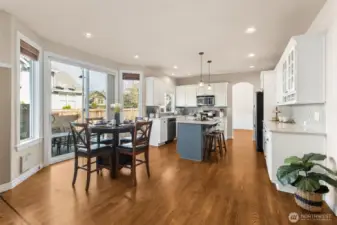 A bright breakfast nook overlooks the backyard and corner-lot greenery. Morning light fills the space, creating a cheerful start to each day. It’s a cozy spot for coffee or casual meals. Gorgeous hardwood floors throughout.