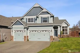 The finished three-car garage offers abundant space for vehicles, storage, and projects. Whether for hobbies or organization, the possibilities are endless. It’s a standout feature for any homeowner.